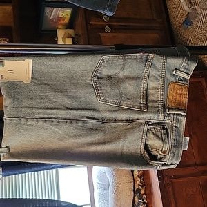 Levi 550 relaxed fit straight blue jeans. A little fray on the hem. 40x30